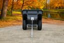 ATVCB ATV trailer black plastic tub, straight-on rear view showing dual wheels and hitch tongue