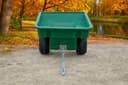 ATVCG ATV trailer green plastic tub, straight-on front view showing dual wheels and hitch tongue