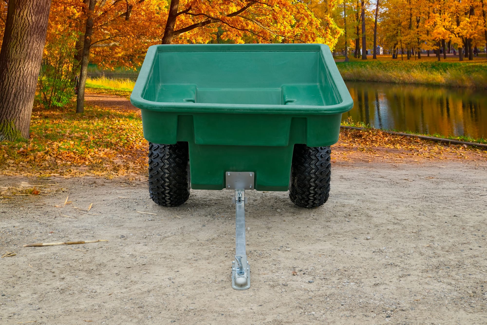 ATV Trailers green plastic utility trailer, front view showing tow hitch and dual rear wheels