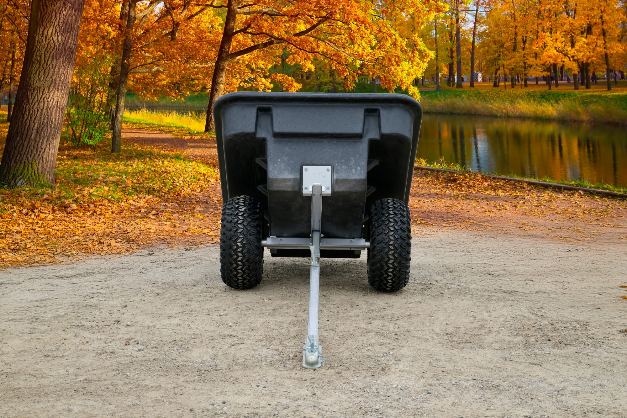ATVCB ATV trailer black plastic tub, straight-on rear view showing dual wheels and hitch tongue
