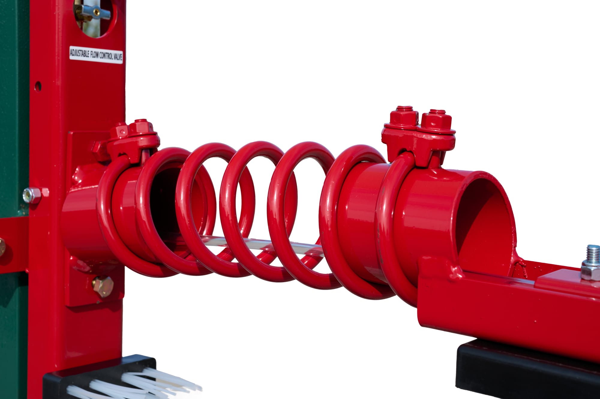 D-95 cattle oiler close-up of red coil spring arm assembly, front angle showing pipe clamp hardware